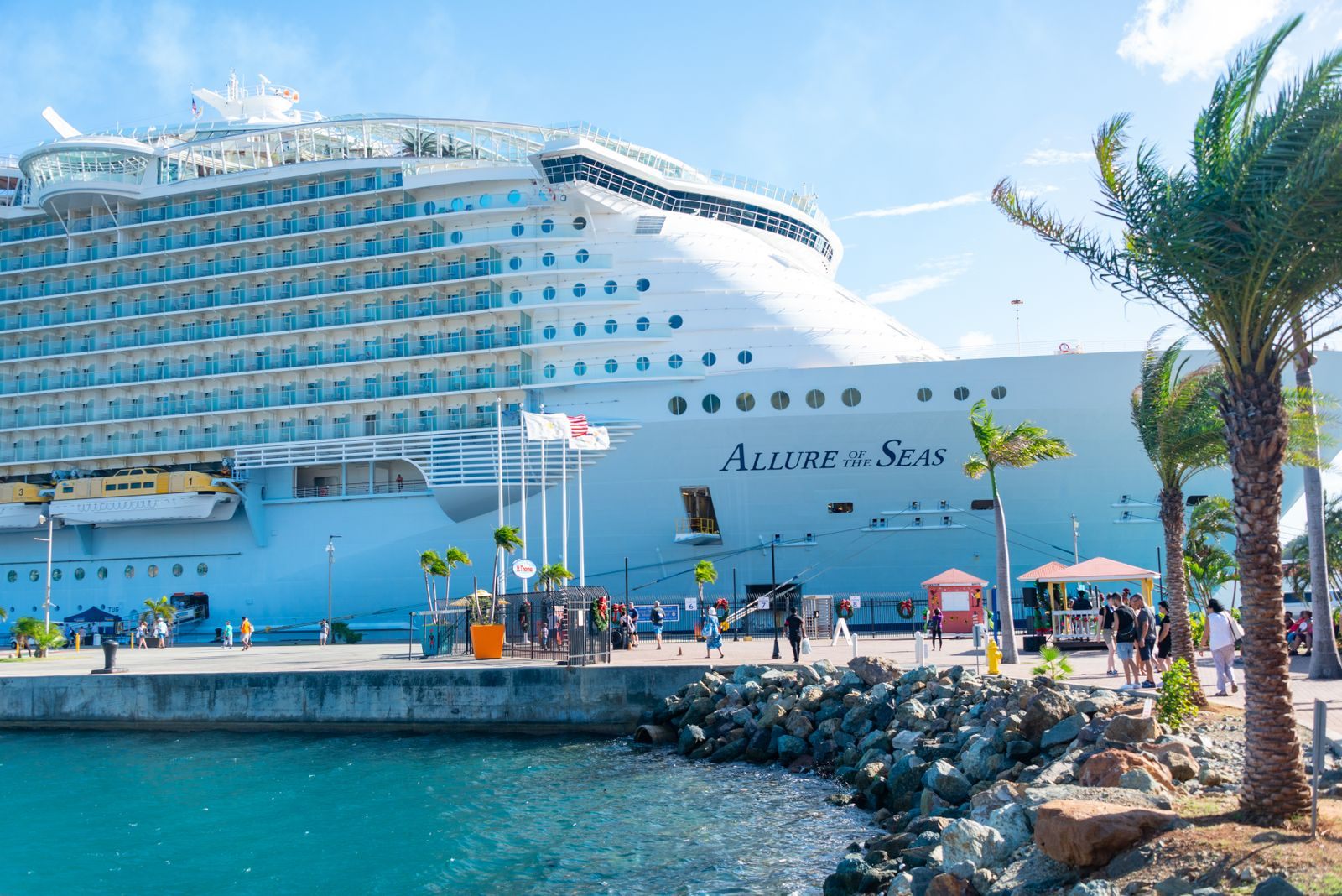 Royal Caribbean’s Allure of the Seas, an Oasis-class sister of the biggest Royal Caribbean ship, docked at a palm-lined pier